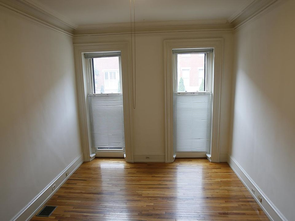 living room , high ceiling and fan with lights, plus track light.