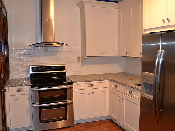 Kitchen w/SS double oven and glass stovetop, side-by-side re