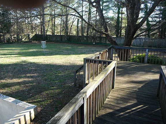 deck and fenced backyard