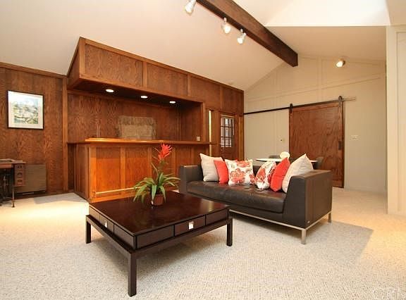 Another view of family room (bar in the background).  Sliding oak door leads to kitchen.