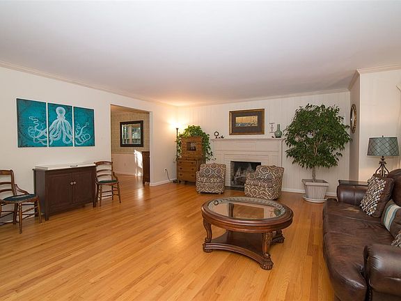 Features include hardwood flooring, crown molding and a wood-burning fireplace.