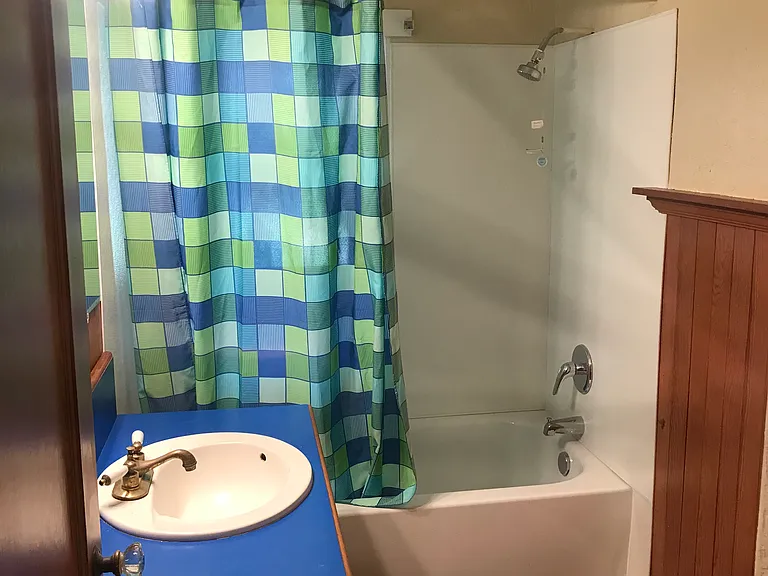 This bathroom complete with a real tub is between the two smaller bedrooms.