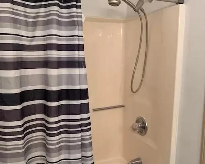 BATHROOM TUB/SHOWER. TILE FLOORS.