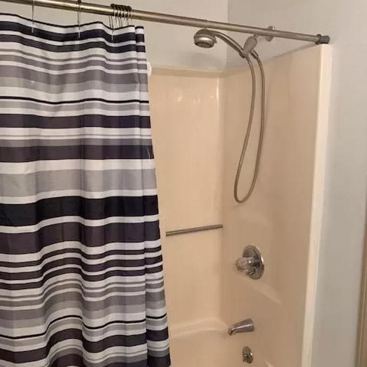 BATHROOM TUB/SHOWER. TILE FLOORS.