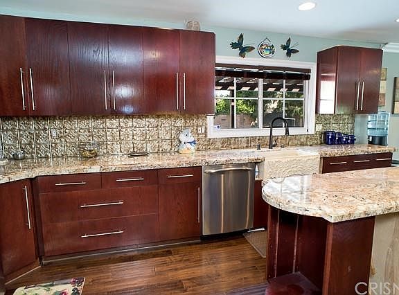 The kitchen location overlooks the backyard pool area.