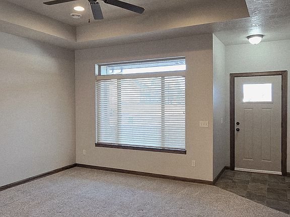 Living Room View 2: Large picture window with Transom Window, Front entry.