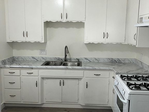 Super cute kitchen with new counters, faucet and sink.