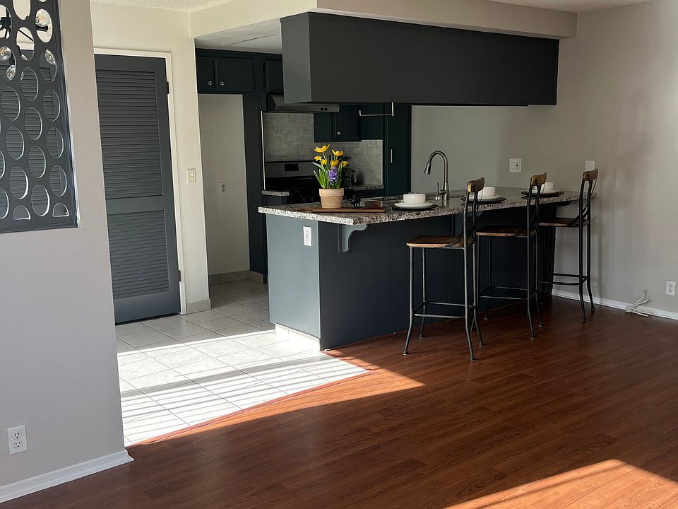 Morning light pours through large windows, and welcomes you into the spacious living room.