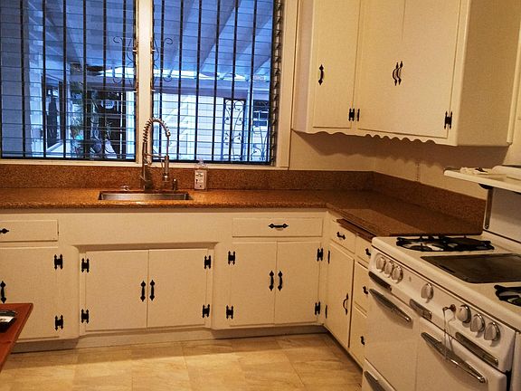 Large eat in kit hen with Wedgwood antique stove and tons of storage.