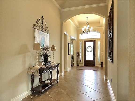 Soaring ceilings throughout lends dramatic effect to this foyer.