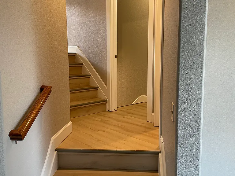 Stairs to 2nd Level, Powder Room, and Garage