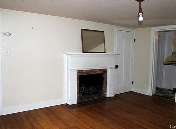 Formal dining room with fireplace and wide plank flooring.