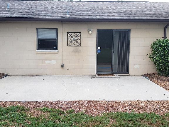 Backyard Patio off Dining Area/Kitchen w electric outlet & sensor security light & roof gutter above patio