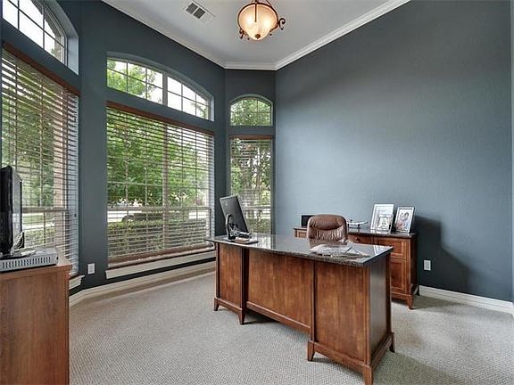 Private office with bay windows and wood blinds.