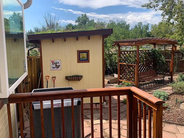 Chicken coop, grape arbor with bench swing, and heat pump