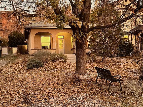 Street view from Northwest corner of property with view of the front yard and bench