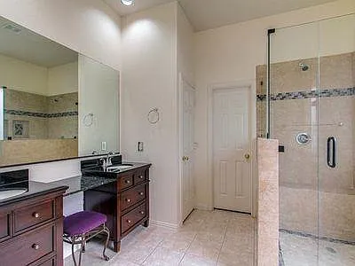 master bath with large walk-in shower with seat. Dual sinks, large walk-in closet and enclosed toilet
