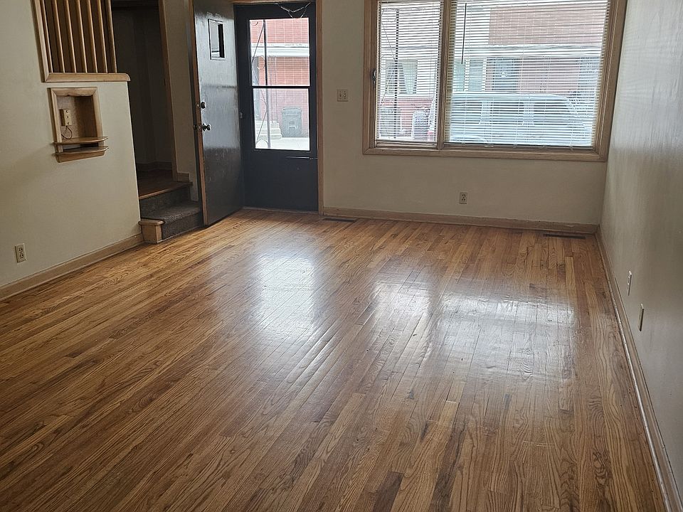 View from inside front door of main living area. Real wood flooring.
