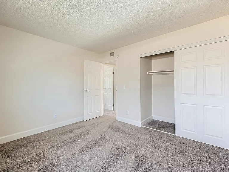 Experience comfort in this airy bedroom with modern closet space.