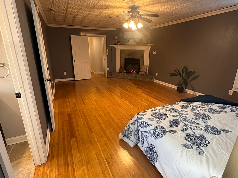 Spacious main bedroom with electric fireplace with remote.