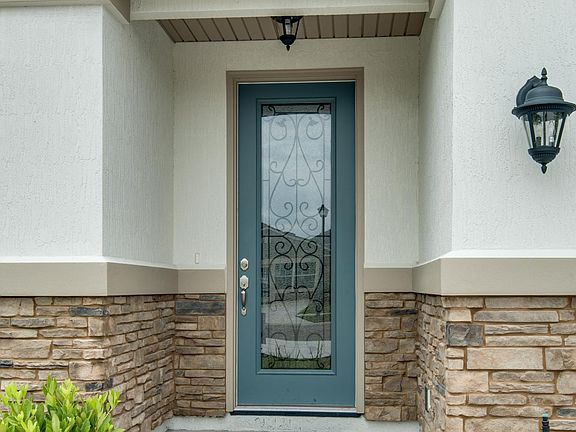 covered front entry with decorative door