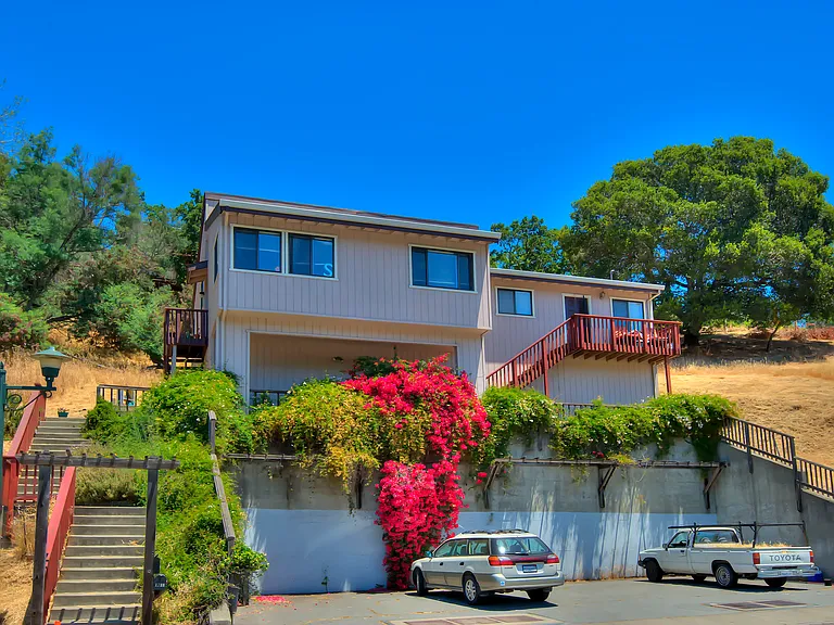 The apt is on the right of this photo and it comes with the 3 parking spaces to the right