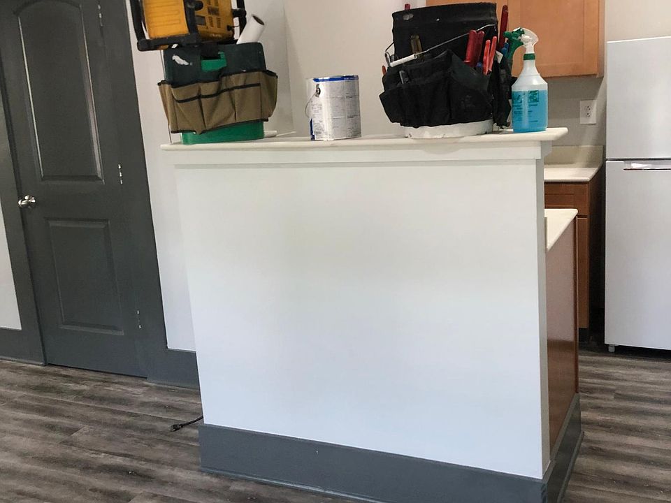 Corian kitchen counters ,room for bar stools. Stainless steel range hood for cooking.