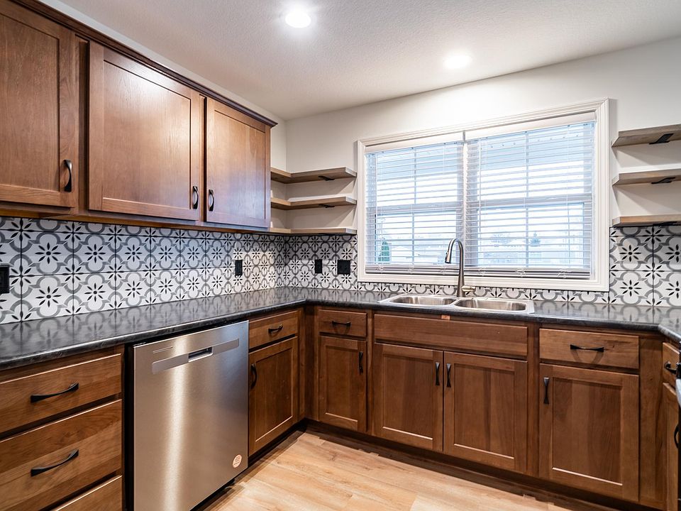 KItchen with back splash and floating shelves, all new appliances.