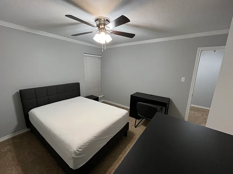 Secondary Bedroom #1, furnished with full size bed, tall dresser, desk, chair, & nightstand. Walk in closet. Private space for occupant of secondary bedroom #1.