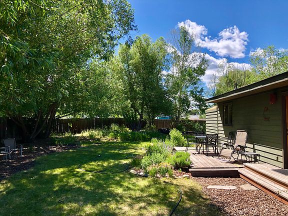 Spacious fended in back yard with gardens.