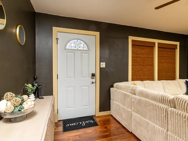 Open and inviting living room featuring a cozy couch, a ceiling fan for comfort, and fun colors that add character and flow.