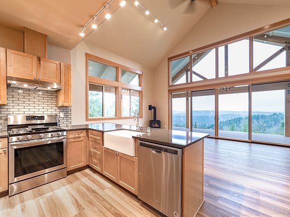 The kitchen flows into this massive great room with vaulted ceilings and is just steps to the sliding doors leading to the covered deck.