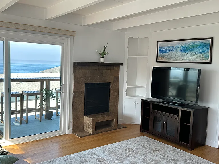Woodburning fireplace, 47" Sony TV, original watercolors by renowned Laguna Festival of Arts artist