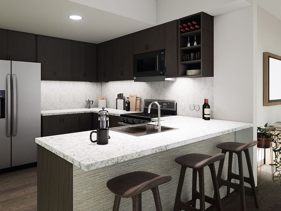 Kitchen with granite countertops, gourmet stainless steel appliances, and breakfast bar