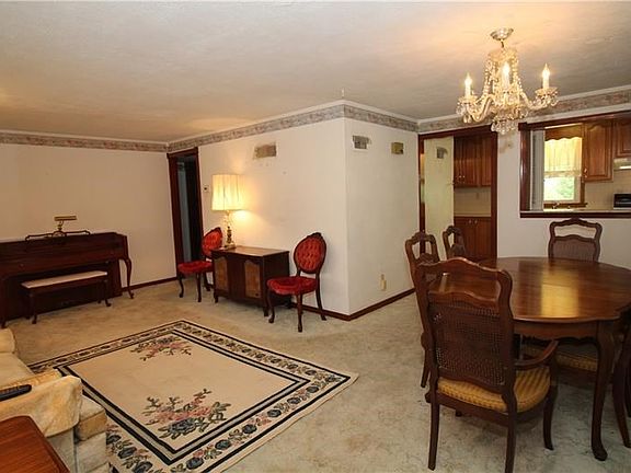 The beautiful chandelier and pass-through to the kitchen make this a great space for entertaining.