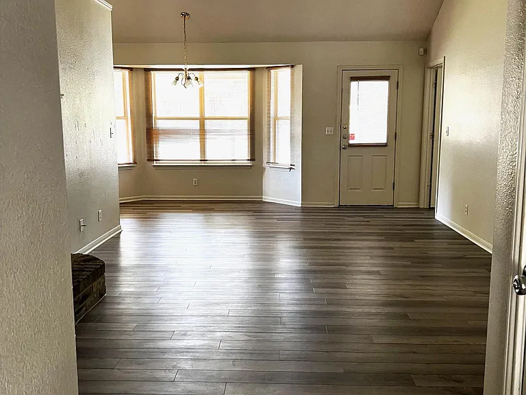 VIEW OF LIVING ROOM & DINING AREA FROM FRONT DOOR