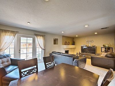 View of living room from dining area, notice the French door leading out to th