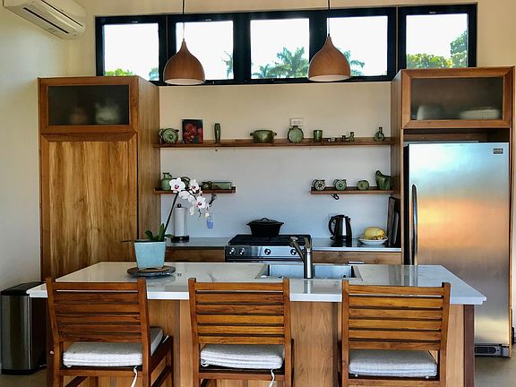 This labor of love cottage has a custom Bali teak wood kitchen fully equipped. It was shipped from Bali! Split system air conditioning, gas stainless steel stove. The kitchen is fully equipped for your stay.
