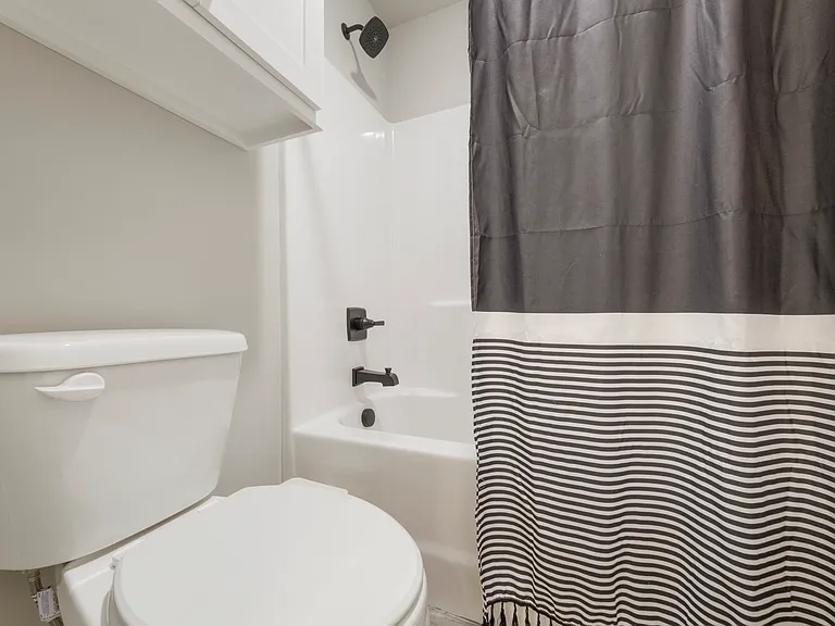 Jack and Jill bathroom has a separate tub/shower combo and toilet area