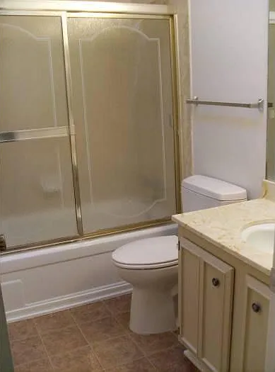 Full bathroom #2 with full bathtub and glass enclosure.