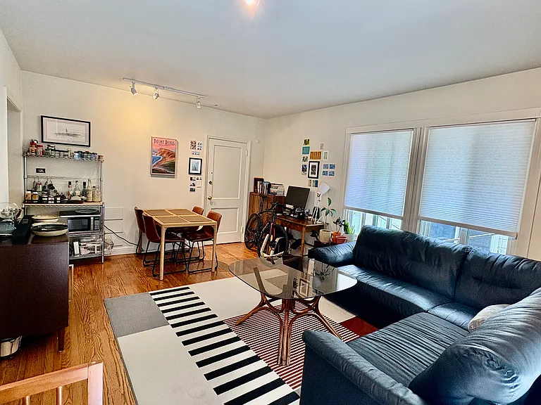 Spacious and bright main room with hardwood floors