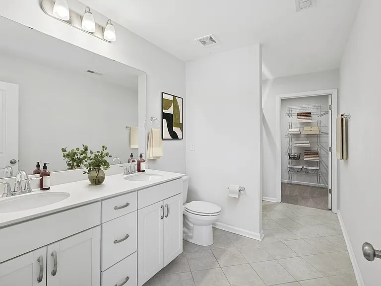 Upgrade Package Primary bath with dual sink vanity, granite countertops, and tile flooring