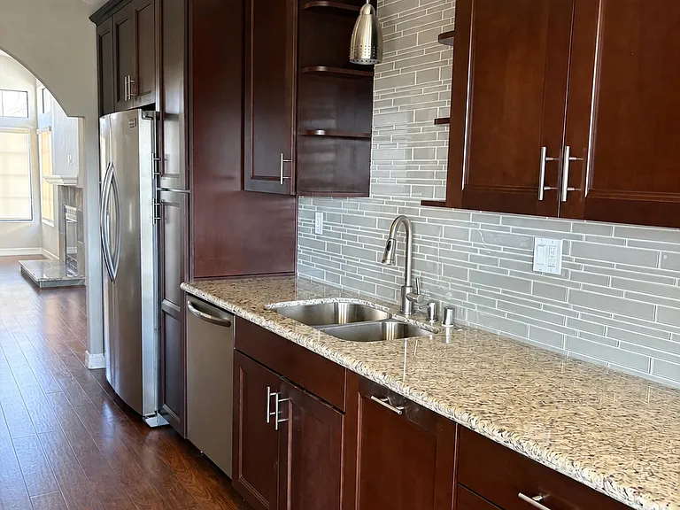 Kitchen with Frigidaire refrigerator with ice and water dispenser.