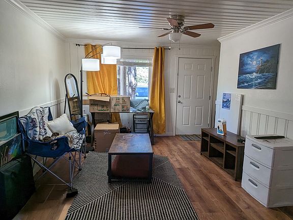 View of front room as standing in the dining room facing front door. (Personal belongings not included)
