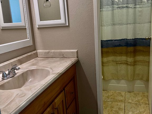 Bath vanity and adjacent bathroom