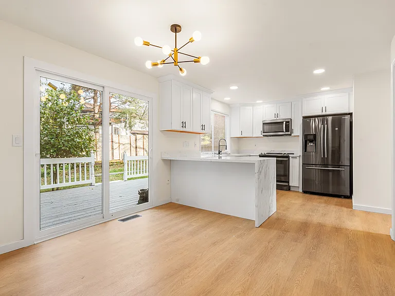 Enjoy a spacious dining area filled with natural light and lovely views of the beautifully landscaped backyard.