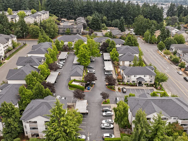 Bird's-eye view of our apartment community with beautifully landscaped grounds, covered parking, and easy access to nearby roads.
