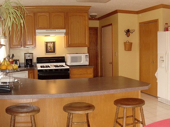 Fully equipped kitchen features oak cabinetry, large pantry 