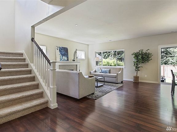 Looking into the greatroom / open-concept living area, access the upper level from this wide staircase.