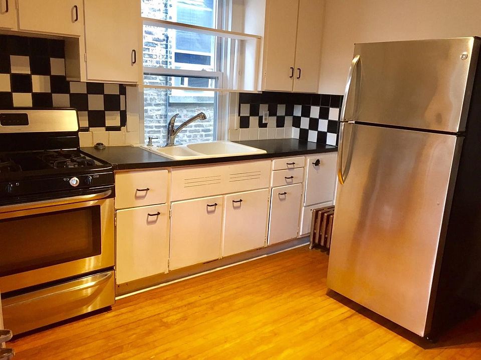 Art Deco eye popping kitchen light and bright. stainless steel appliances, nifty double bowl sink with pull-out sprayer makes dish washing a breeze, and the glow of the hardwood floor lends a nice warmth to the stainless steel .